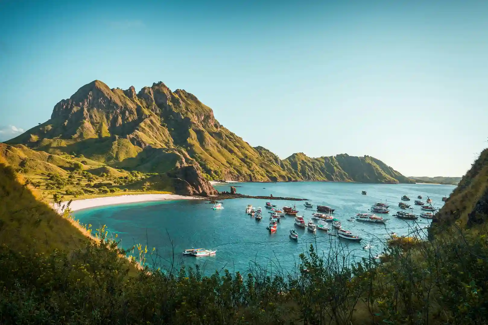 Komodo National Park’s rugged hills and boats, home to Komodo dragons and top diving featured by icanfly.