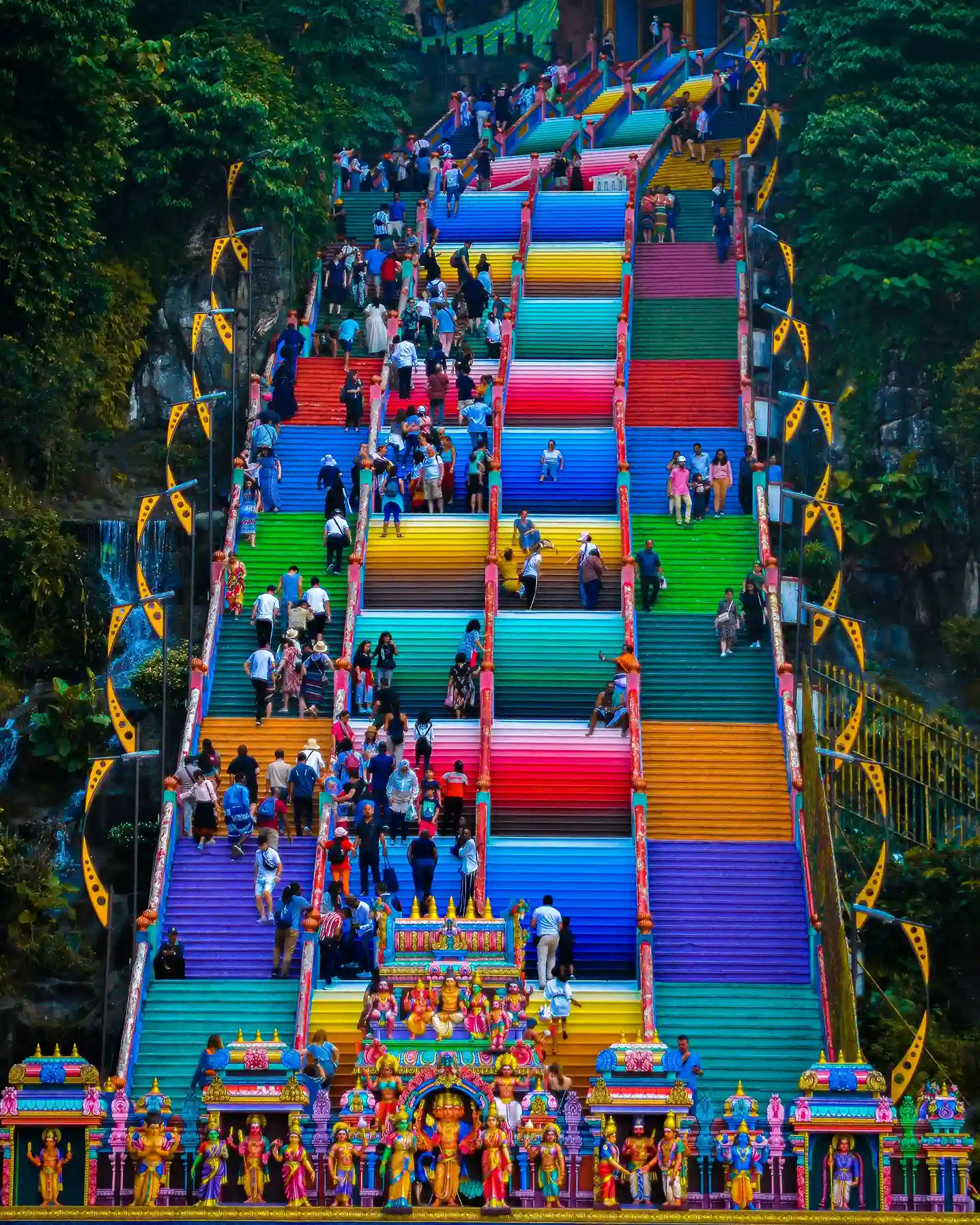 Colourful staircase leading to Batu Caves, a famous Hindu temple site in Malaysia, highlighted by icanfly for cultural exploration and spiritual tourism.