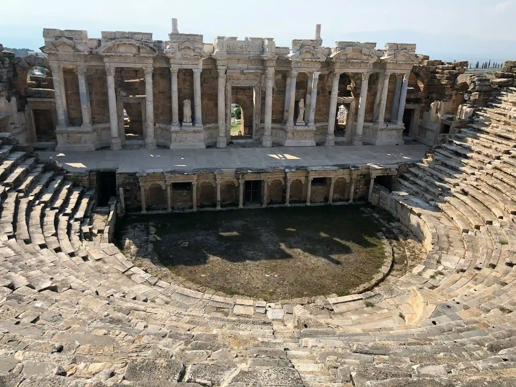 Ruins of Ephesus including stone structures and amphitheater, a best-preserved ancient city featured by icanfly in Turkey itineraries.