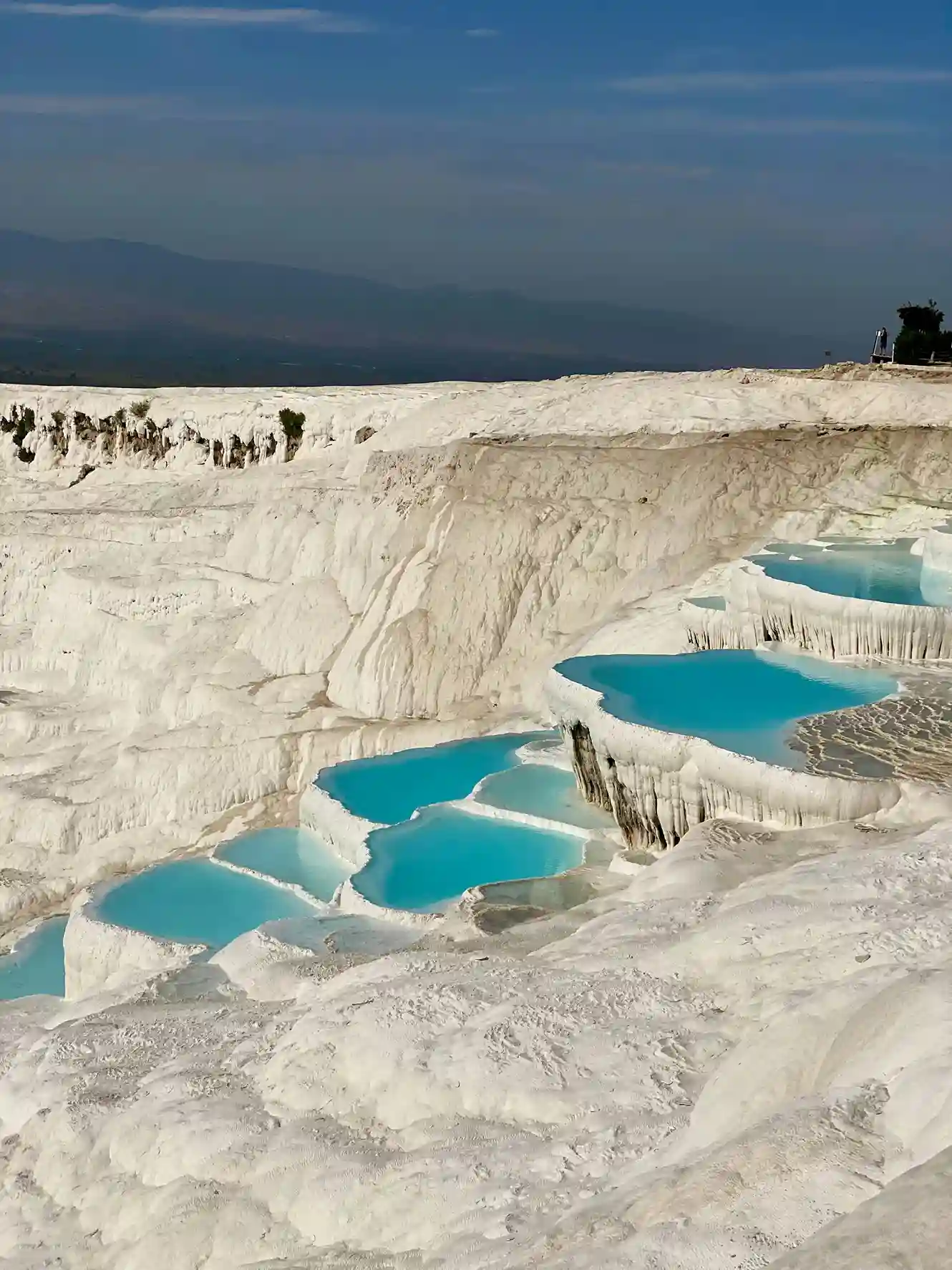 White travertine terraces and turquoise thermal pools of Pamukkale, a striking natural wonder highlighted by icanfly in Turkey tours.