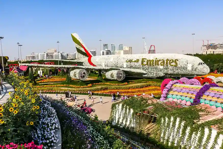 A vibrant outdoor garden featuring millions of colorful flowers arranged in creative designs and seasonal displays.