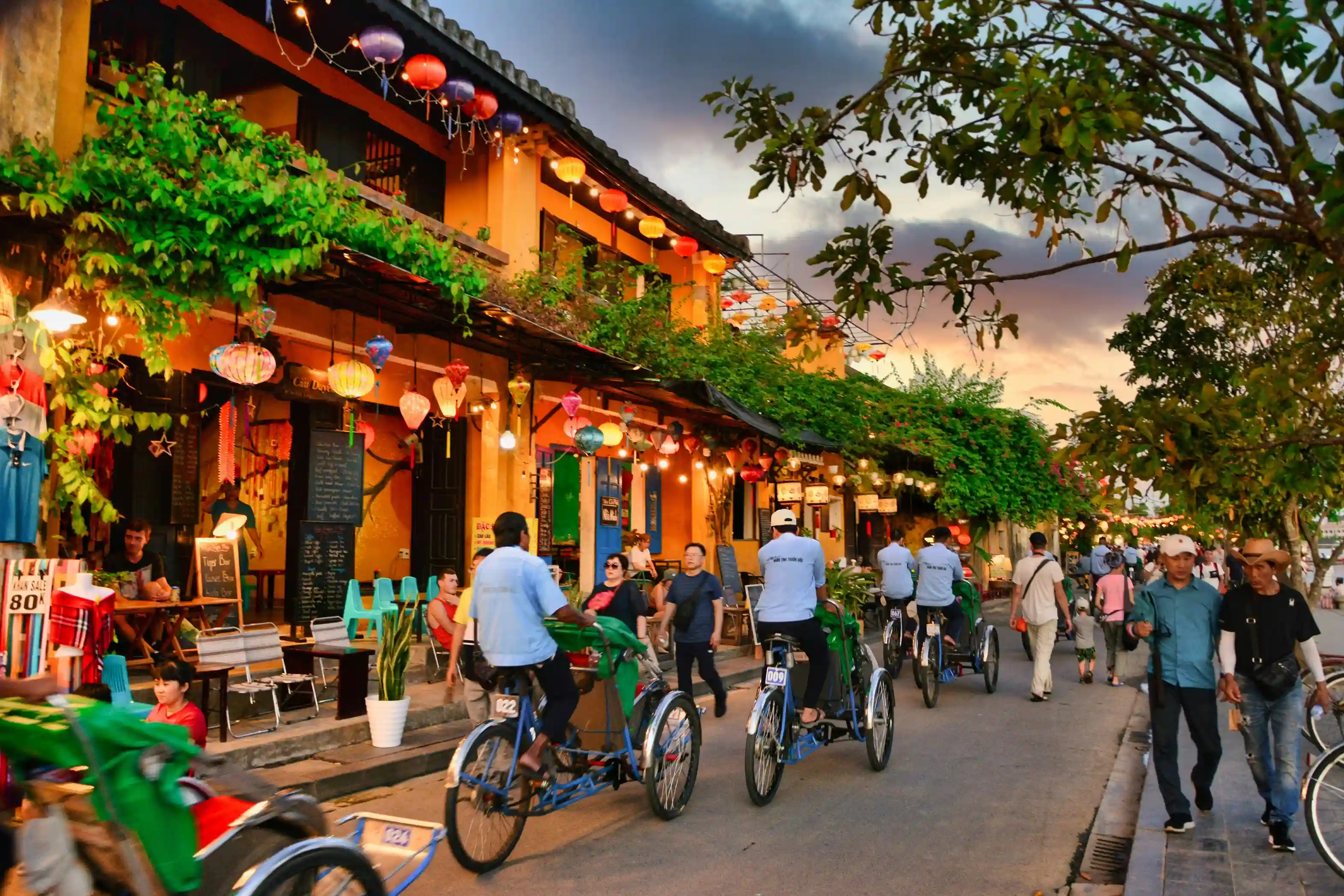 Colourful lanterns, bicycles, and riverside cafes line the streets of Hoi An’s ancient town in Vietnam, a vibrant cultural gem promoted by icanfly.