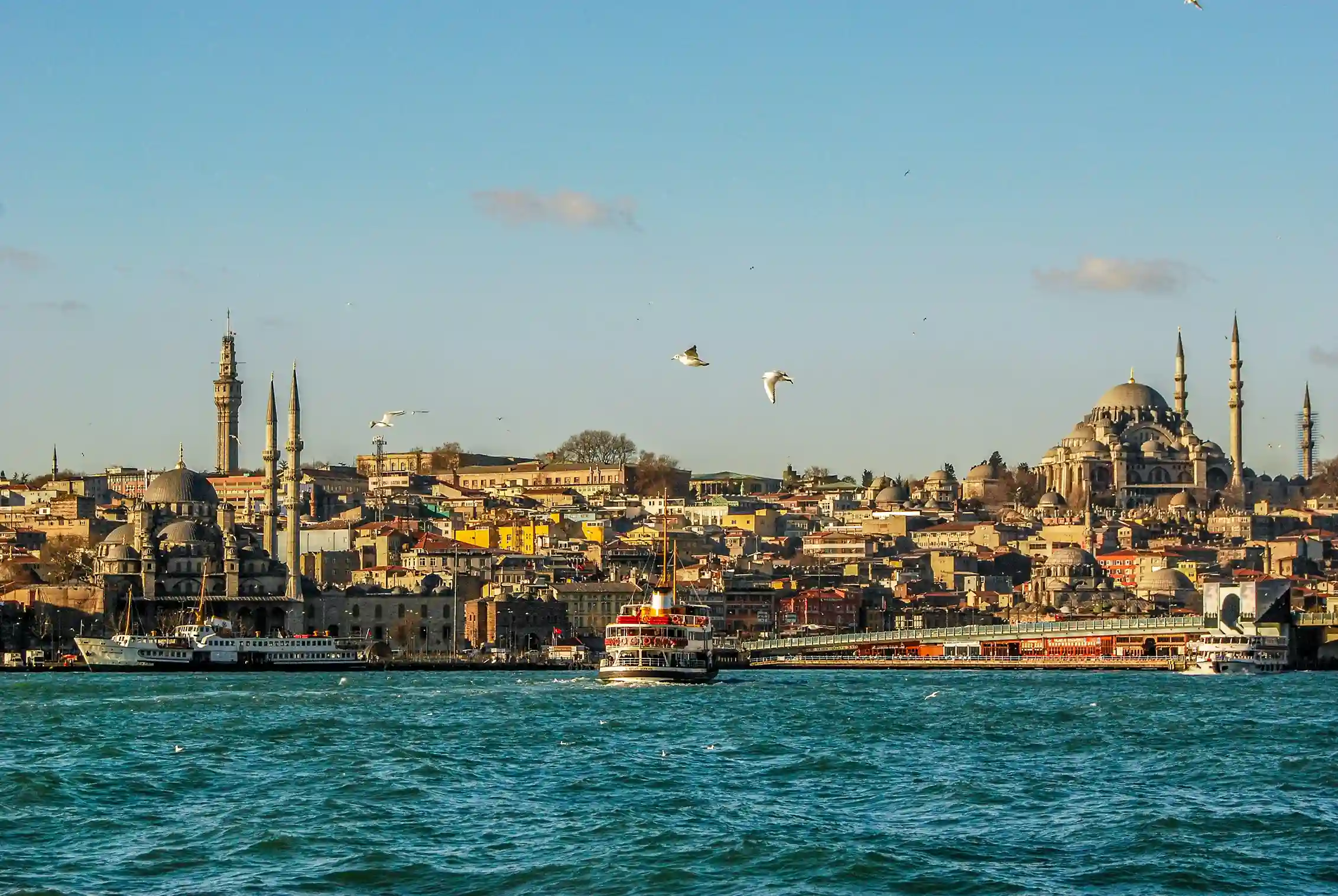 Istanbul skyline with mosques and waterfront at sunset, representing Turkey’s cultural blend featured by icanfly.