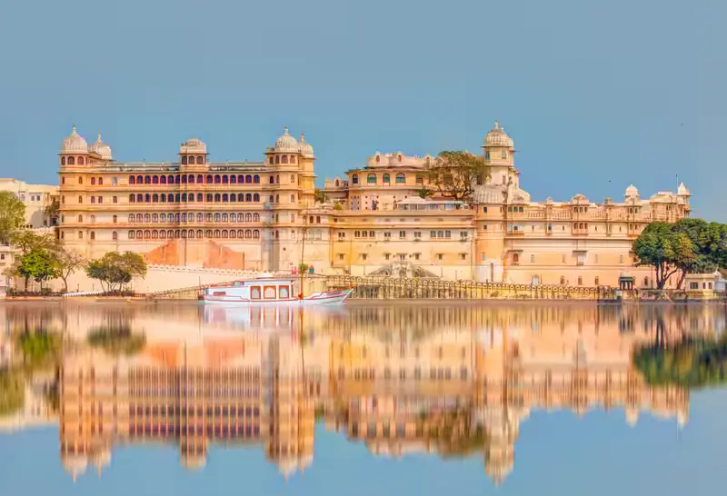 A majestic palace complex overlooking Lake Pichola, showcasing royal architecture and scenic views.