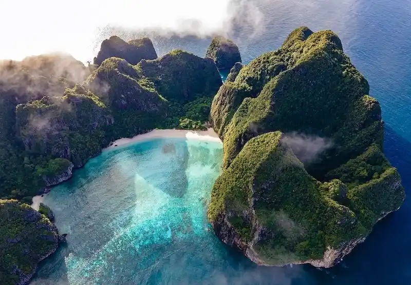 A stunning bay surrounded by dramatic cliffs and clear waters, known worldwide for its natural beauty and calm atmosphere.